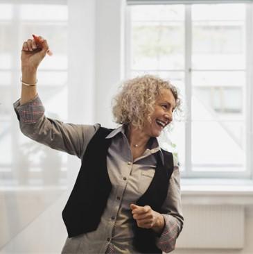 Smiling woman at the whiteboard.