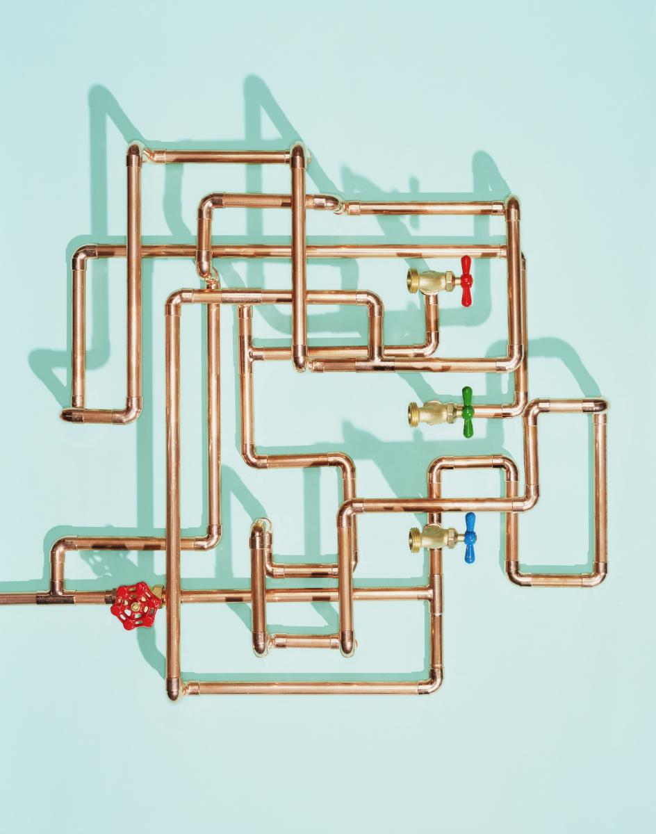 A grid of copper water pipes with 4 valves.