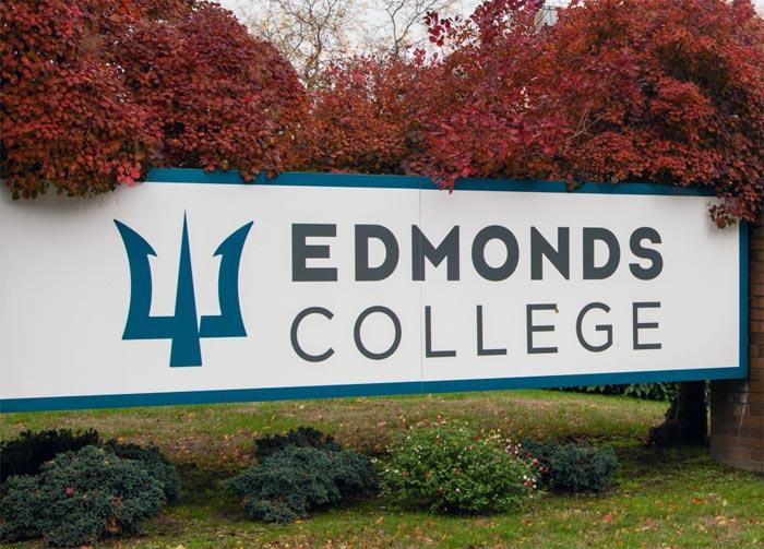 Edmonds College sign with fall leaves behind it.
